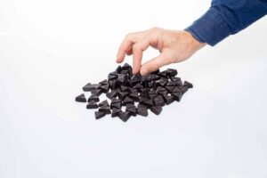 a hand picking Dutch Double Salt Liquorice