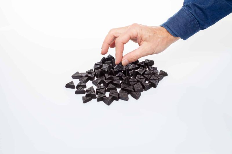 a hand picking Dutch Double Salt Liquorice
